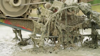 Mechanical tiller in muddy water in paddy field, agricultural machinery