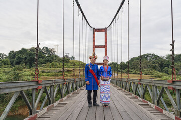 young couple of Rawang people in traditional Rawang dress at Kaungmulone Bridge across Mali Kha River in Putao, Kachin state. Myanmar