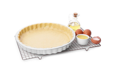 Quiche pan with fresh dough, oil and eggs isolated on white