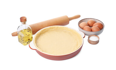 Pie tin with fresh dough, rolling pin and ingredients isolated on white. Making quiche