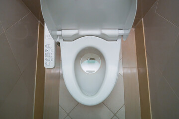 High Tech toilet with automatic bidet installed in public restroom - obrazy, fototapety, plakaty