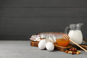 Allergenic food. Different fresh products on light gray wooden table, space for text