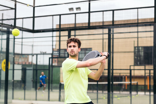 man playing paddle tennis. backhand