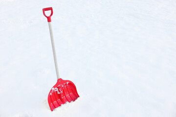 Snow shovel with wooden handle outdoors. Space for text