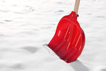 Snow shovel with wooden handle outdoors, closeup. Space for text