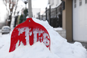 Snow shovel with wooden handle outdoors. Space for text