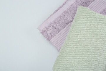 Different soft towels on light grey background, top view. Space for text