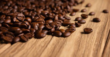 Close-up of roasted coffee beans on wooden background