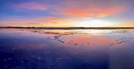 Sun Setting over the Uyuni Salt Flat, Bolivia, reflected in the saline water. 