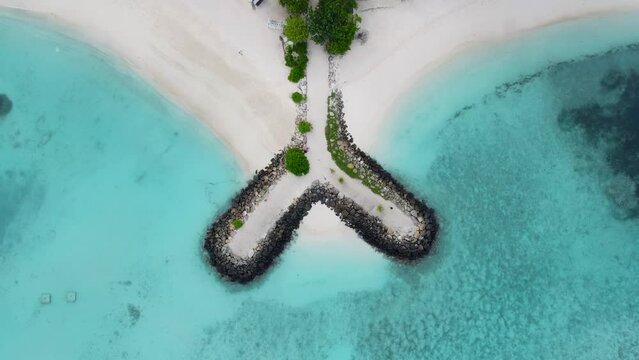 Beach with stones on Maldives, Maafushi island with clear blue ocean