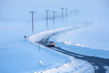 A road and electrical wires covered in snow