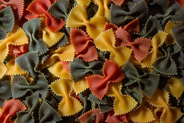 Uncooked Vibrant Colored Farfalle Pasta: A Culinary Canvas of Multicolored Bow-Tie Macaroni,...