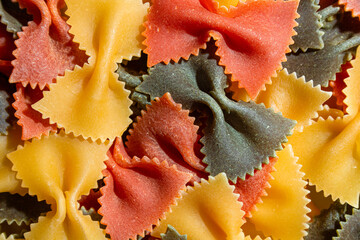 Uncooked Vibrant Colored Farfalle Pasta: A Culinary Canvas of Multicolored Bow-Tie Macaroni,...
