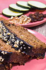 Pastry made of zucchini with nuts and raisin on wooden board. Delicious dessert