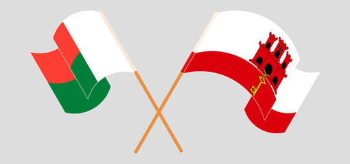 Crossed and waving flags of Madagascar and Gibraltar