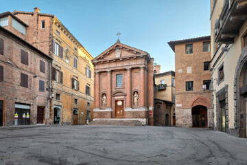 Fototapeta na wymiar Siena, Italy. View of Piazza Tolomei square with Chiesa di San Cristoforo
