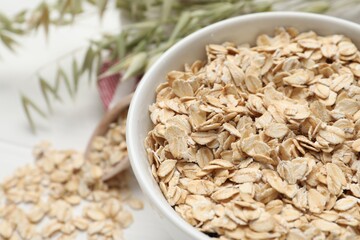 Bowl with oatmeal on table, closeup. Space for text