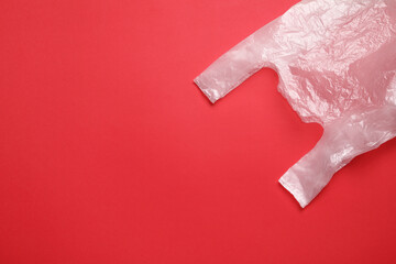 One plastic bag on red background, top view. Space for text