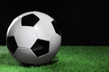 Obraz premium One soccer ball on green grass, space for text. Sports equipment