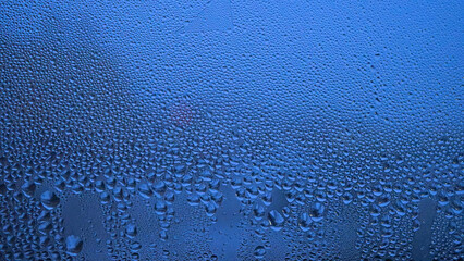 Condensation on window glass in frosty winter weather. Background in the form of small drops on the glass.