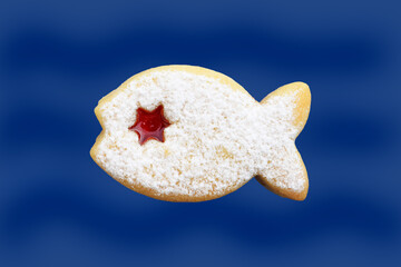 Linzer cookie in a shape of fish isolated on blue background