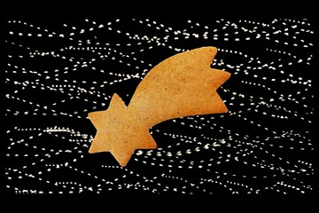 Gingerbread in a shape of comet isolated on background with light effect