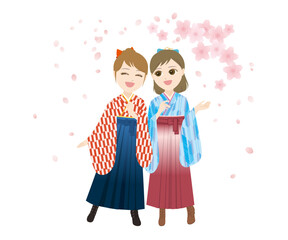 桜の下で笑う袴姿の女性二人