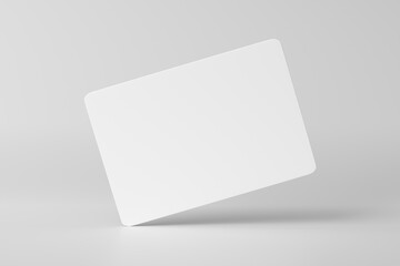 Mockup of a blank white business card hovering on white background.