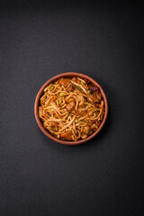 Delicious asian udon dish with vegetables, mushrooms, salt and spices