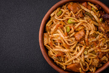 Delicious asian udon dish with vegetables, mushrooms, salt and spices