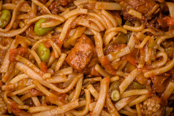 Delicious asian udon dish with vegetables, mushrooms, salt and spices