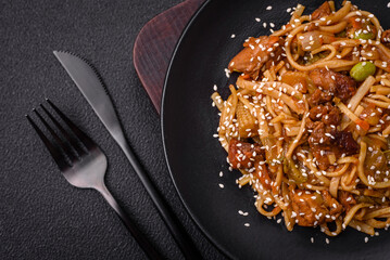 Delicious asian udon dish with vegetables, mushrooms, salt and spices