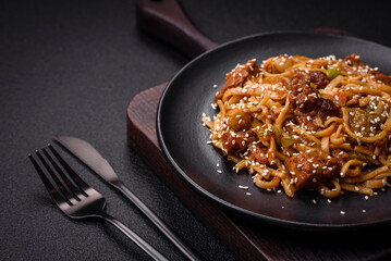 Delicious asian udon dish with vegetables, mushrooms, salt and spices