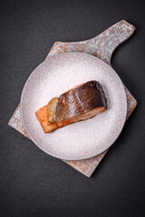 Fresh cooked delicious salmon steak with spices and herbs baked on a grill