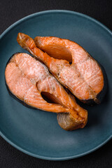 Fresh cooked delicious salmon steak with spices and herbs baked on a grill