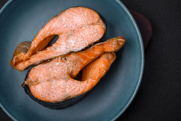 Fresh cooked delicious salmon steak with spices and herbs baked on a grill