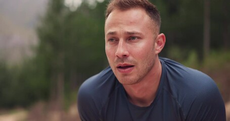 Tired man, runner and breathing in nature for training, workout and fitness goals, endurance and challenge. Young runner, athlete or sports person with fatigue, cardio exercise and break in forest