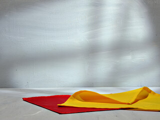 Red and Yellow Fabric on grey Wall Corner