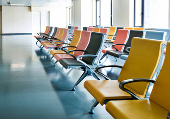 Hospital waiting room with many empty chairs in lines