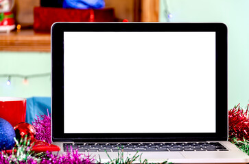 Close-up photo of white screen of laptop standing on festive table at wonderful Christmas Day....