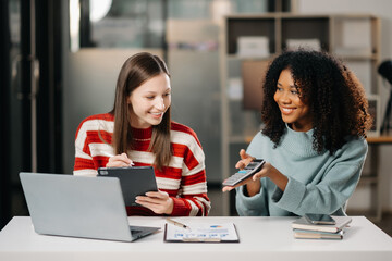 Businesswoman leading team working and using tablet and laptop computer with financial in office