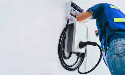 Certified male Electrician Installing Home EV Charger - obrazy, fototapety, plakaty