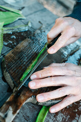 cutting the edges of a piece of aloe gel