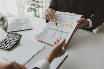 Group of businessmen working together to calculate income, They are revising the financial numbers,...