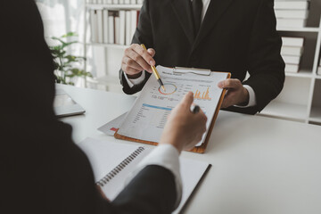 Group of businessmen working together to calculate income, They are revising the financial numbers,...