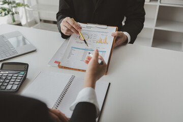Group of businessmen working together to calculate income, They are revising the financial numbers,...
