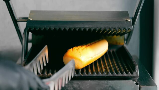 Bread Grilling on Panini Press, Close-up of bread grilling on a professional panini press.