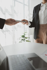 Handing stacks of money to each other in the office, Give money to officials for some...