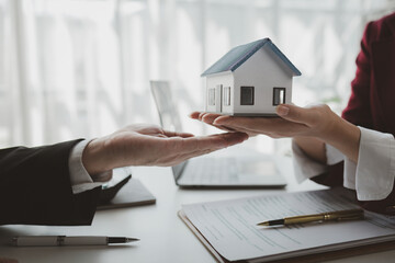 The broker is calculating the buyer's monthly instalment payments, Real estate broker agent...