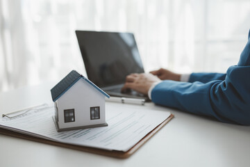 House insurance paperwork, A realtor is explaining home insurance documents to a buyer in his...